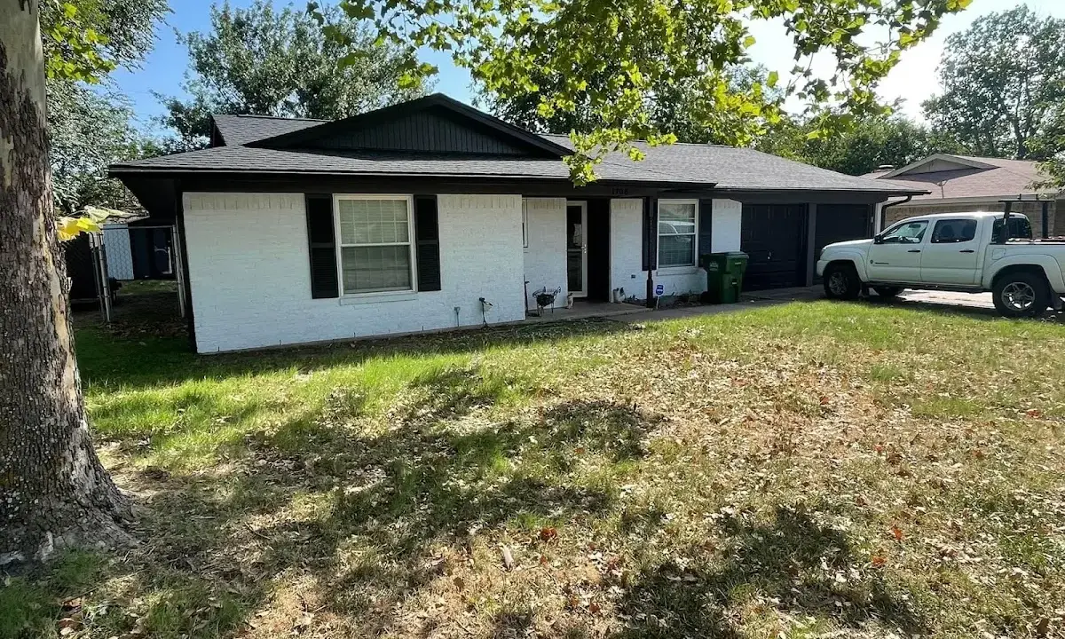 Professional roofing crew working on a residential roof in Homestead Meadows North